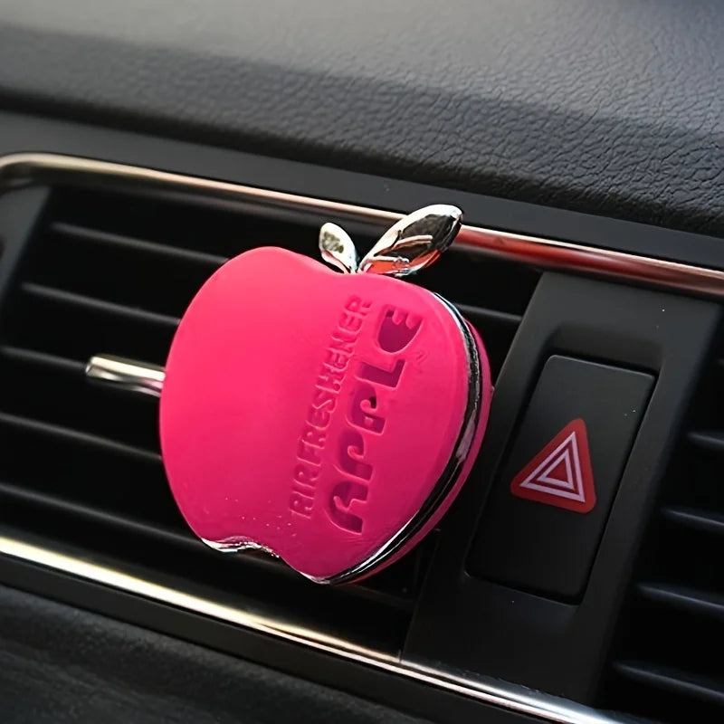 An apple-shaped car air freshener with floral fragrance - featuring a decorative ventilation clip design